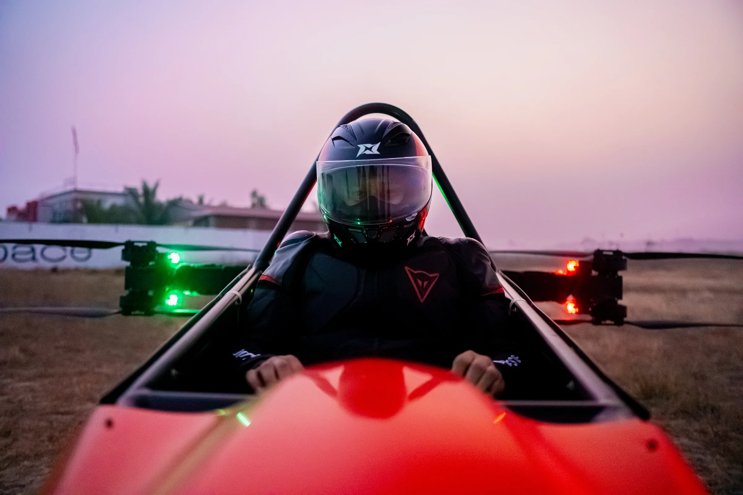 Pilot seated behind the red Genesis nose
