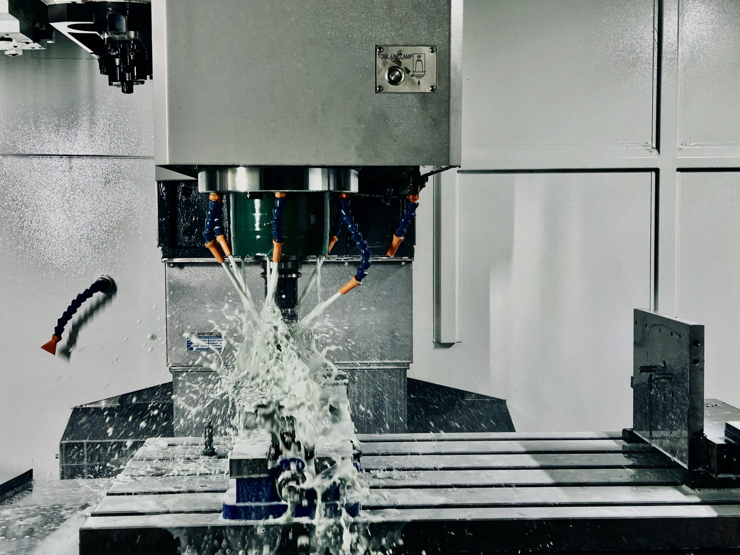 Machining an aircraft component with coolant flowing over the tool